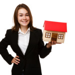 Girl holding model of house isolated on white